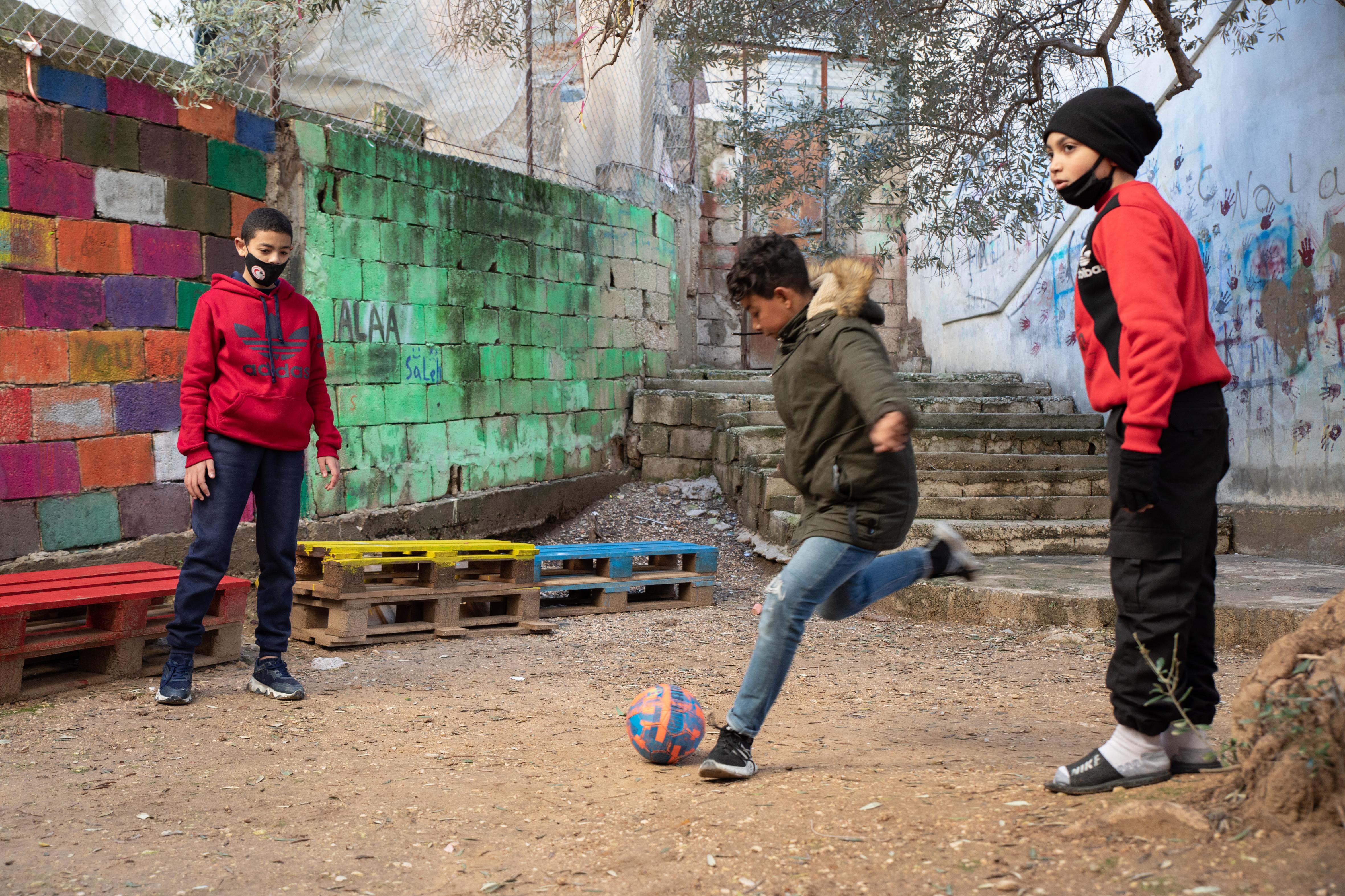 CH1689668_Adam, 14, playing football with his friends at a Save the Children supported education cen