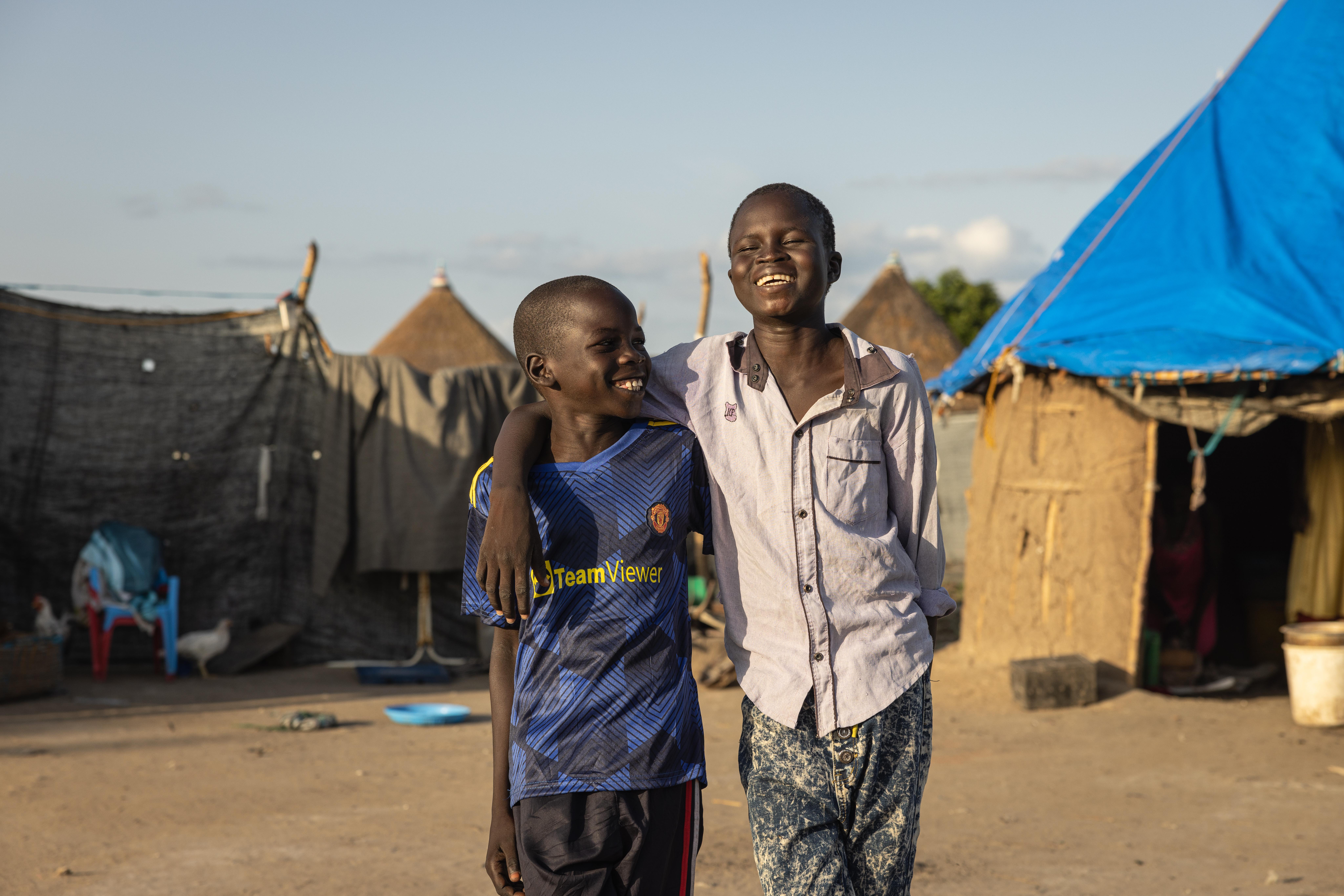CH1703673_Jok, 12, and his best friend Kuol, 10, walking through their village in Akobo West, South 