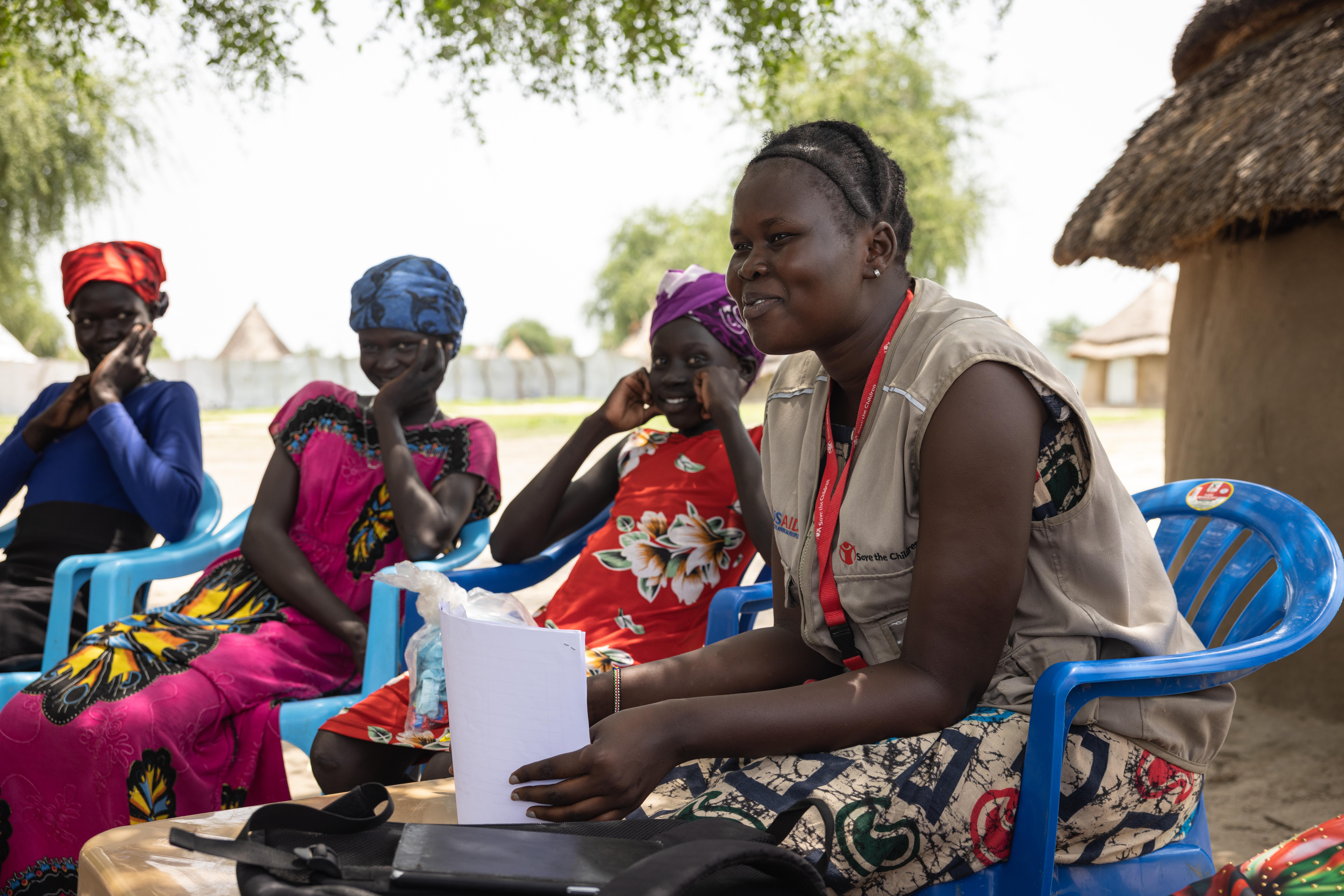 A Save the Children staff member facilitates a discussion with Ayenâs adolescent group.