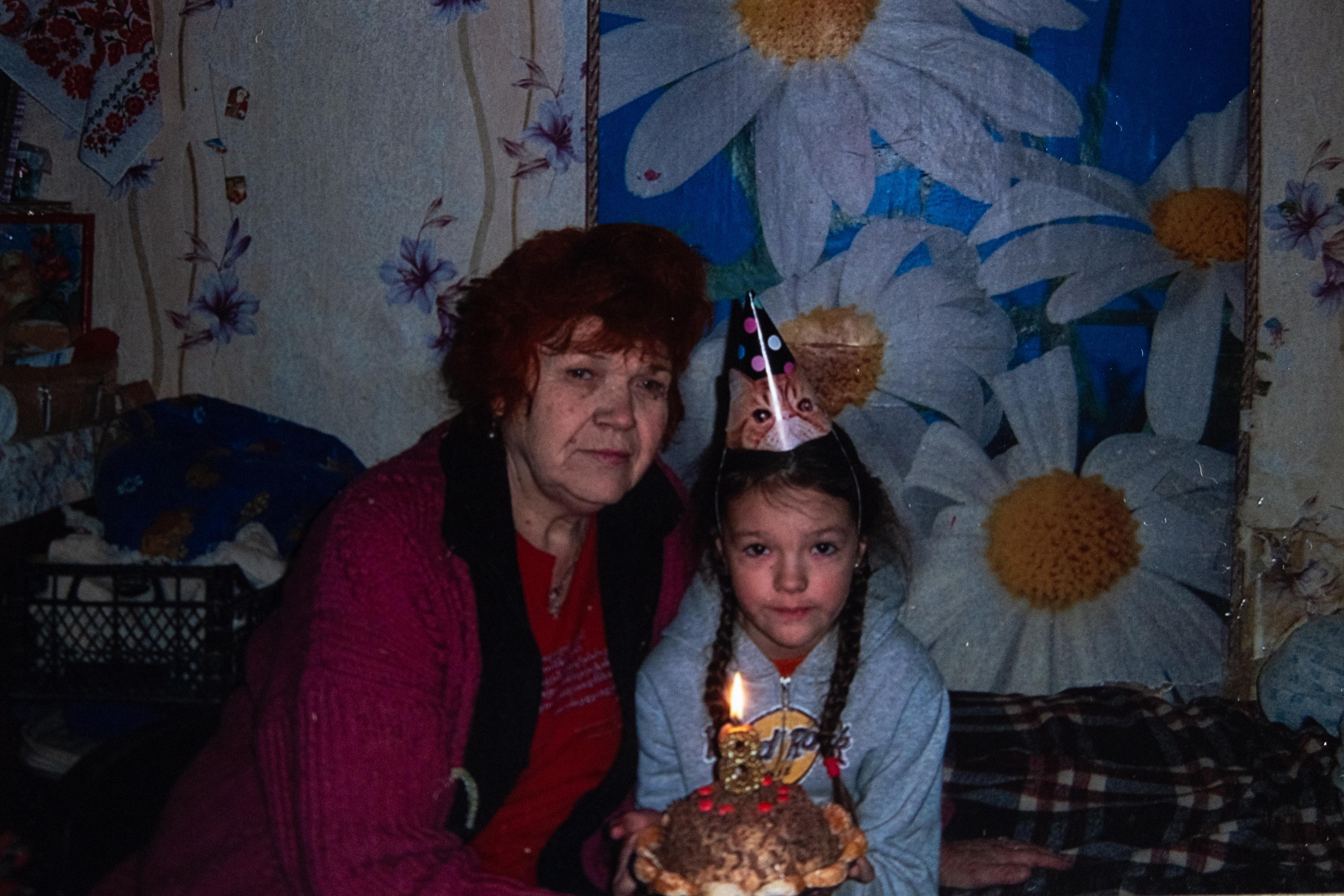 CH1759217_Polina,_8,_celebrating_her_birthday_with_her_68-year-old_grandmother,_Larysa,_after_the_wa