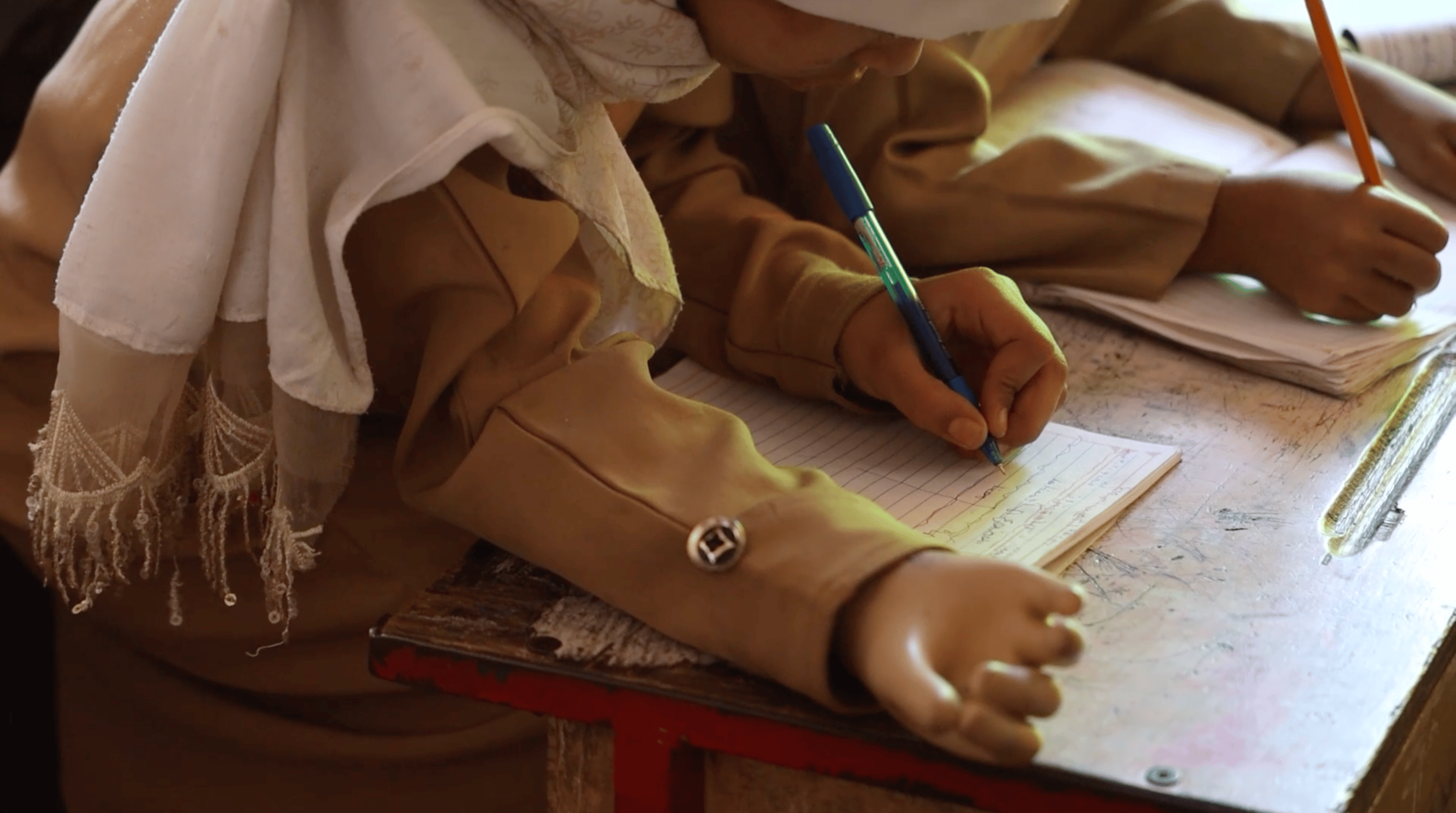 CH1784648_Maha, 10, pictured at school with her prosthetic hand after being severely injured by a la