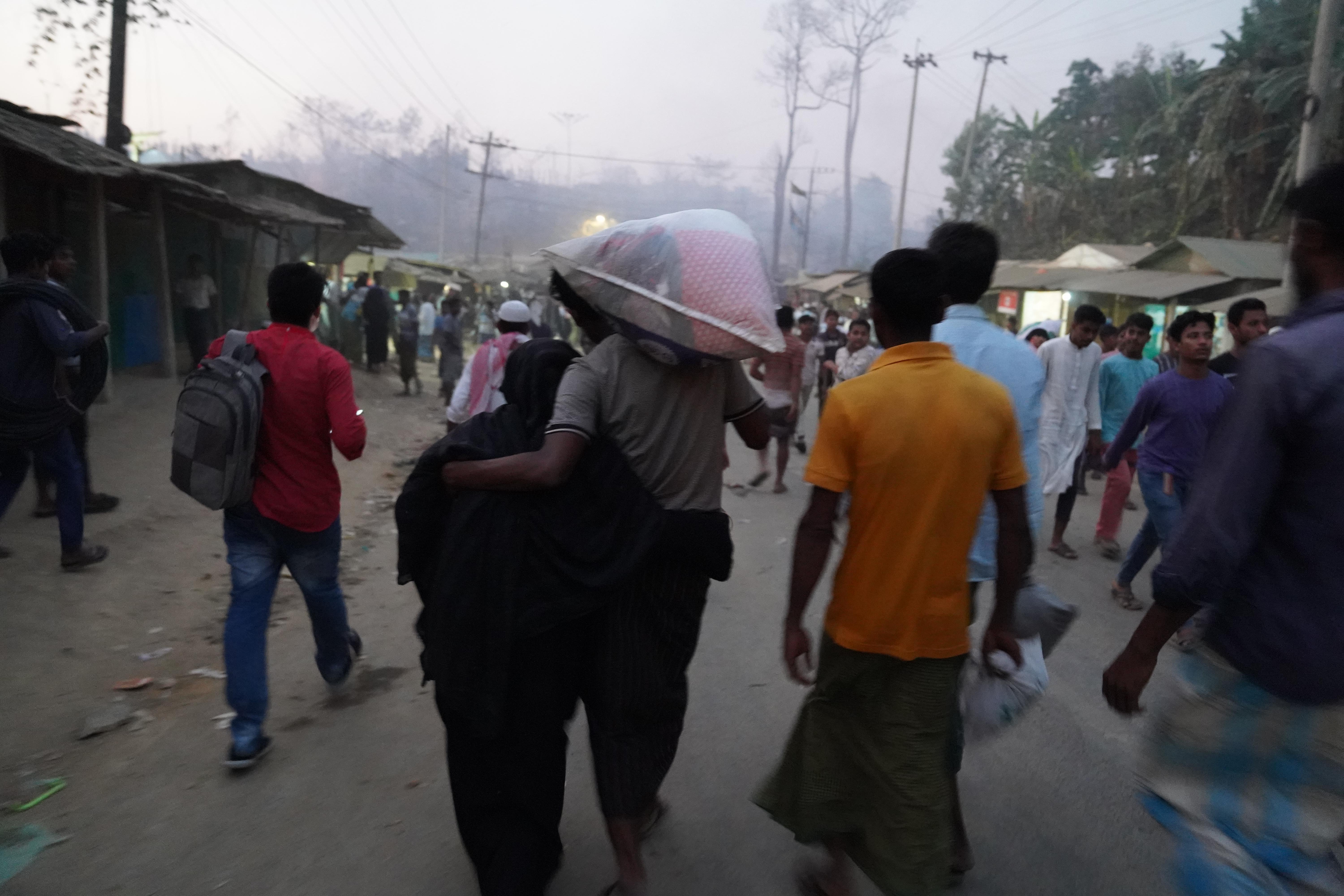 CH1784697_People fleeing the fire the broke out in a Rohingya Camp on March 5, 2023 in Cox's Bazar, 