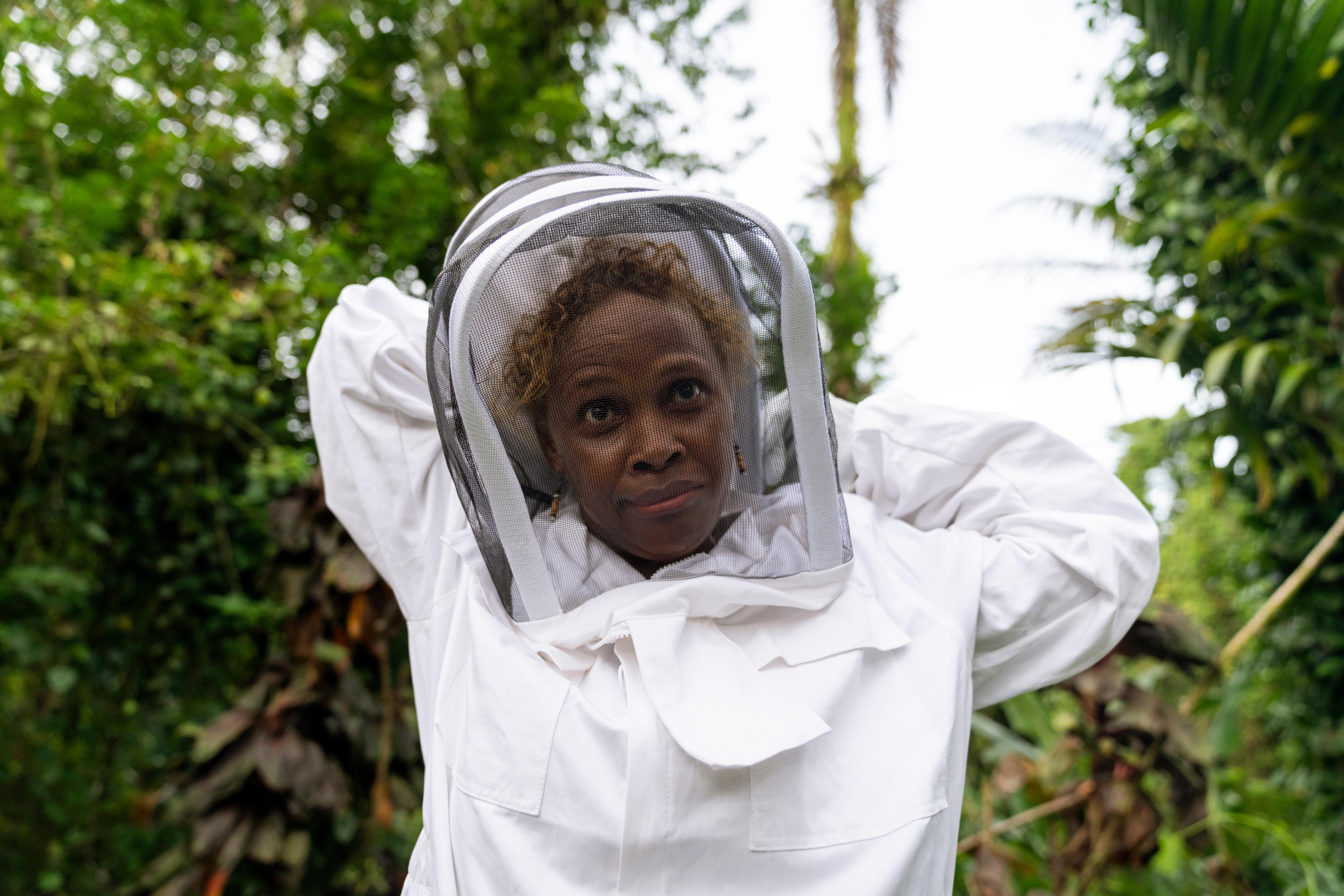 CH1818453_Alison,_43,_puts_on_a_protective_suit_and_veil_ahead_of_a_bee_keeping_training_in_a_remote