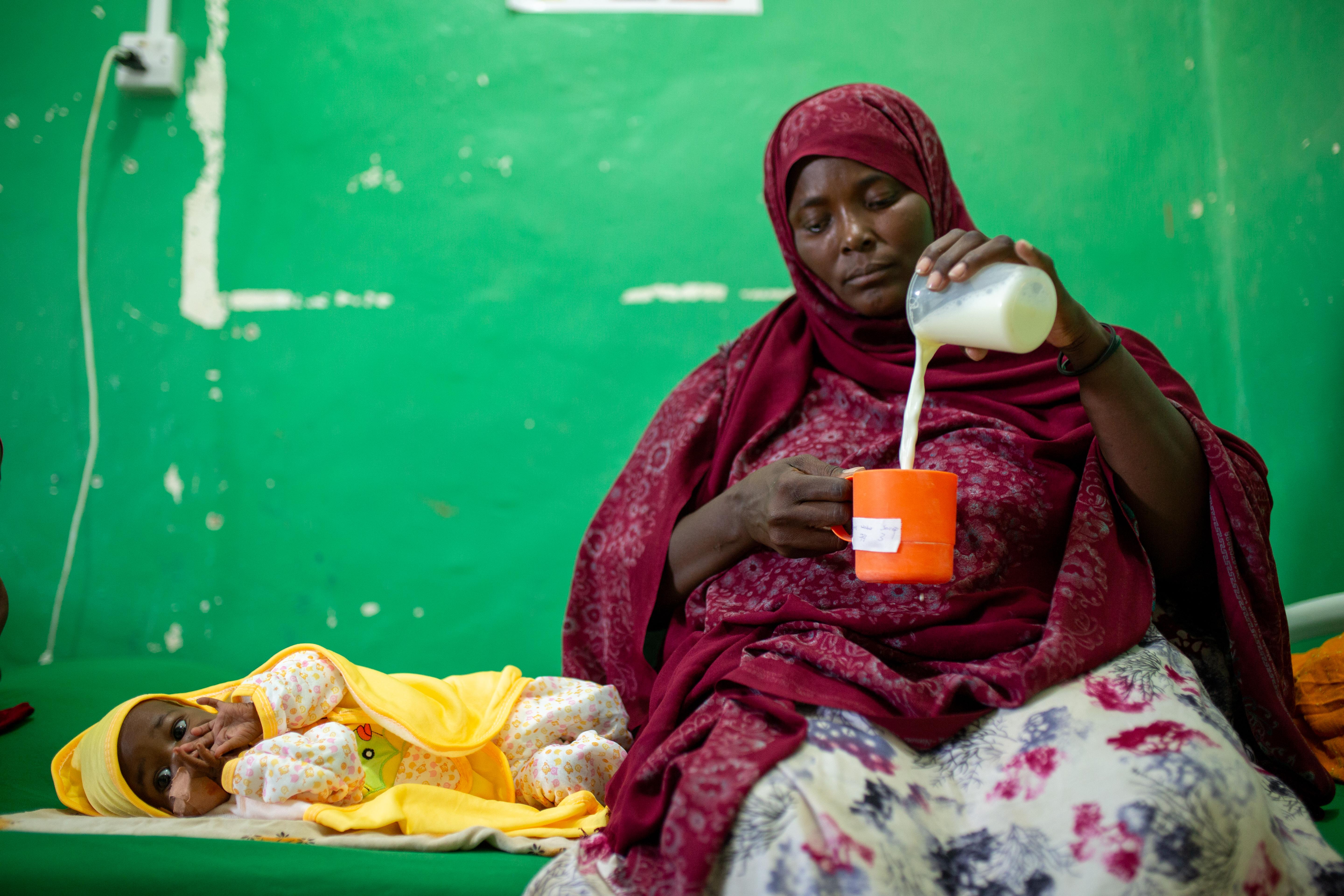 CH1874350_Baby Ahmed, 7 months, is fed fortified milk by his mother Khadra