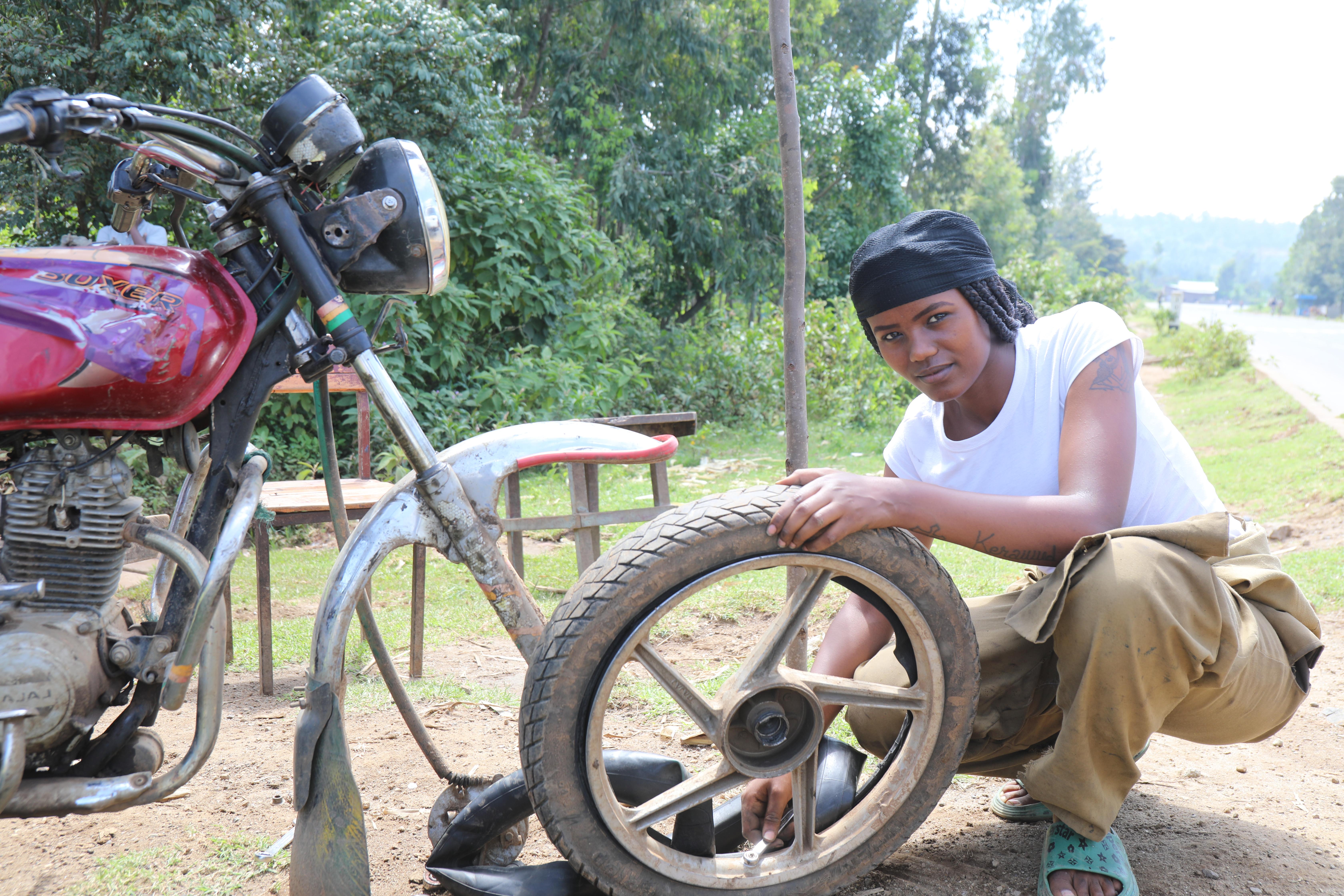 CH1892386_Tsion, 23, repairs a tire