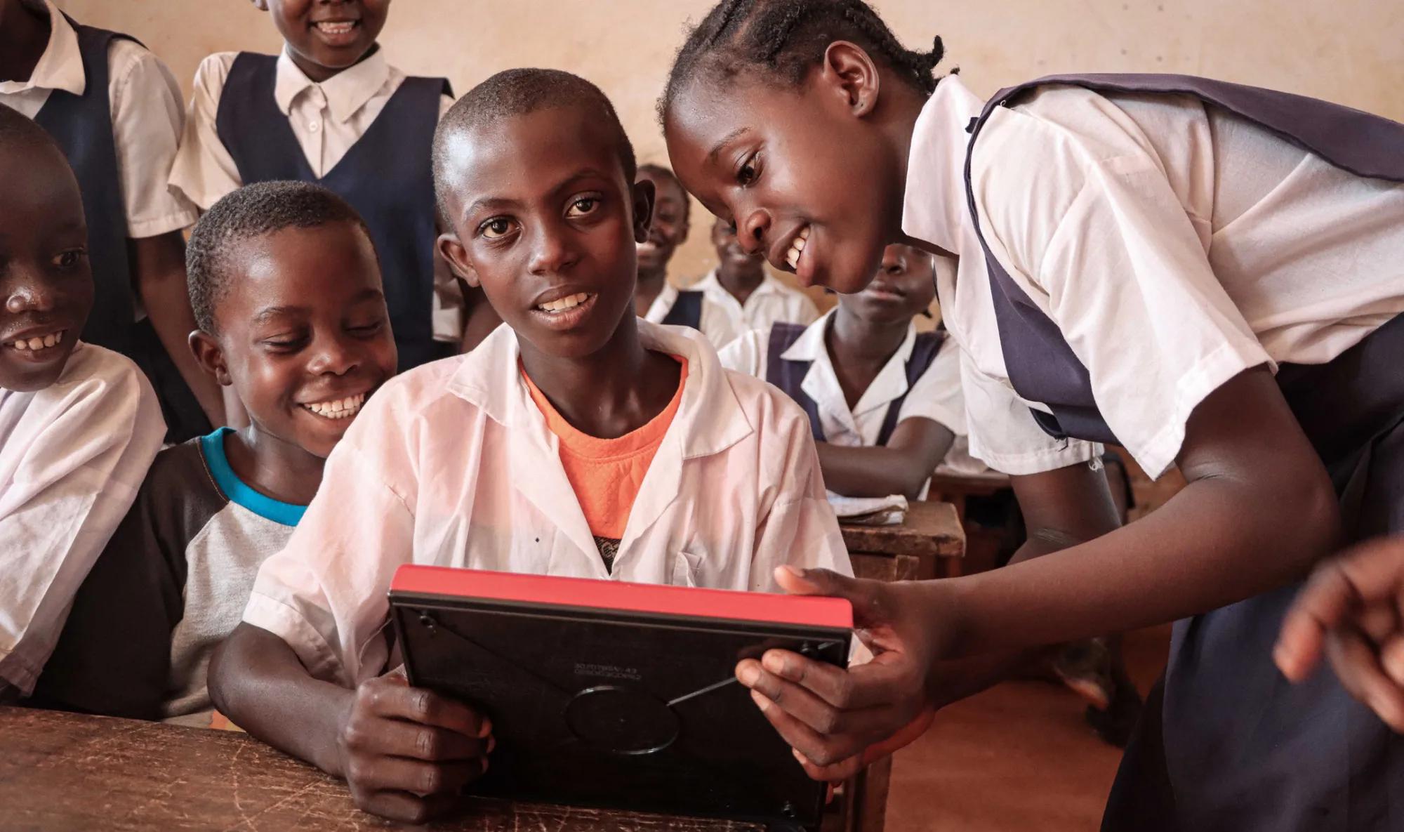 Children in Liberia play with a new Etch-a-sketch���just one of 25,000 new toys delivered from Spin Master���s Toy Movement as part of the Play On! program.