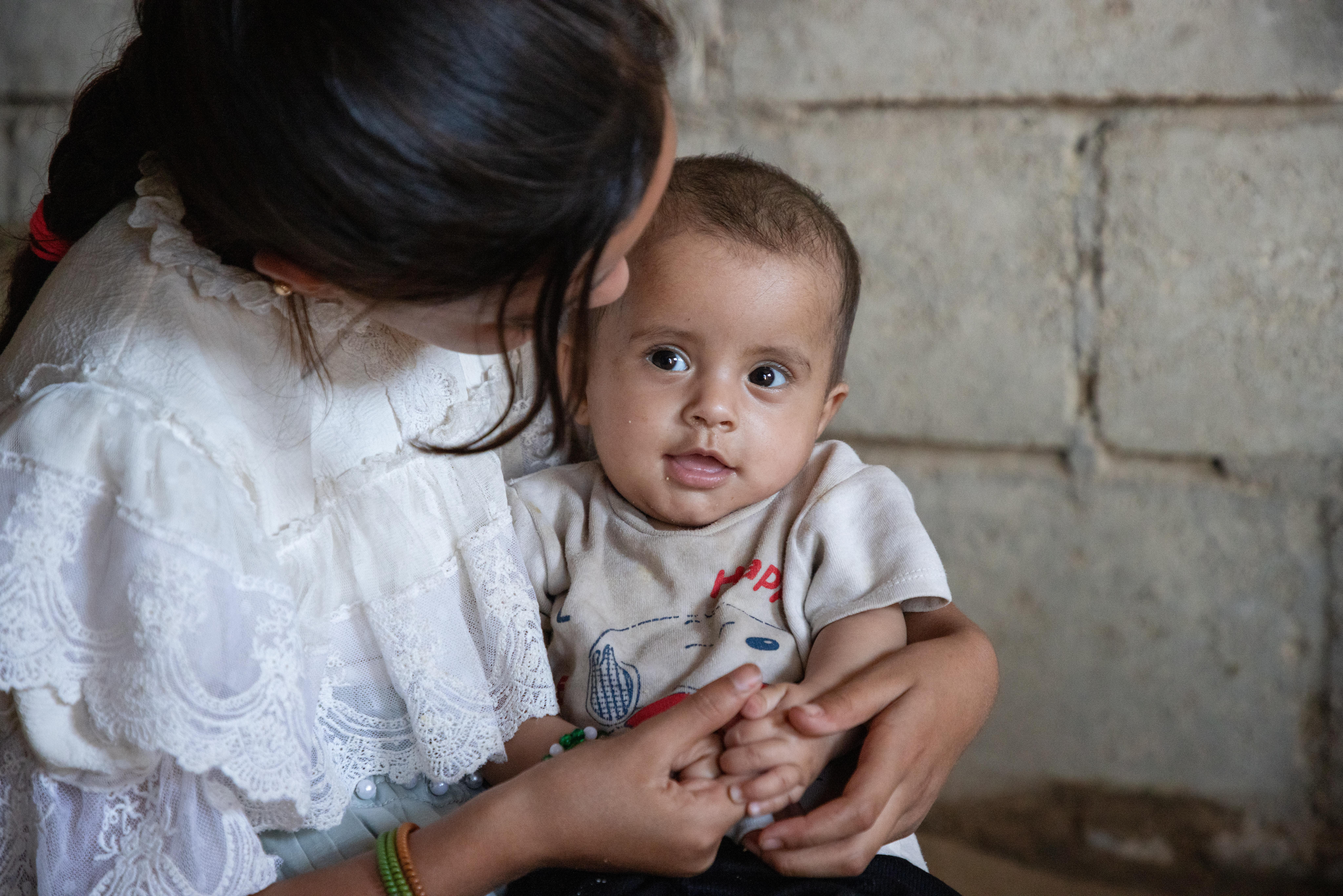 Amal*, 10, plays with her Eight-month-old cousin Sahar*, at Sahar’s home