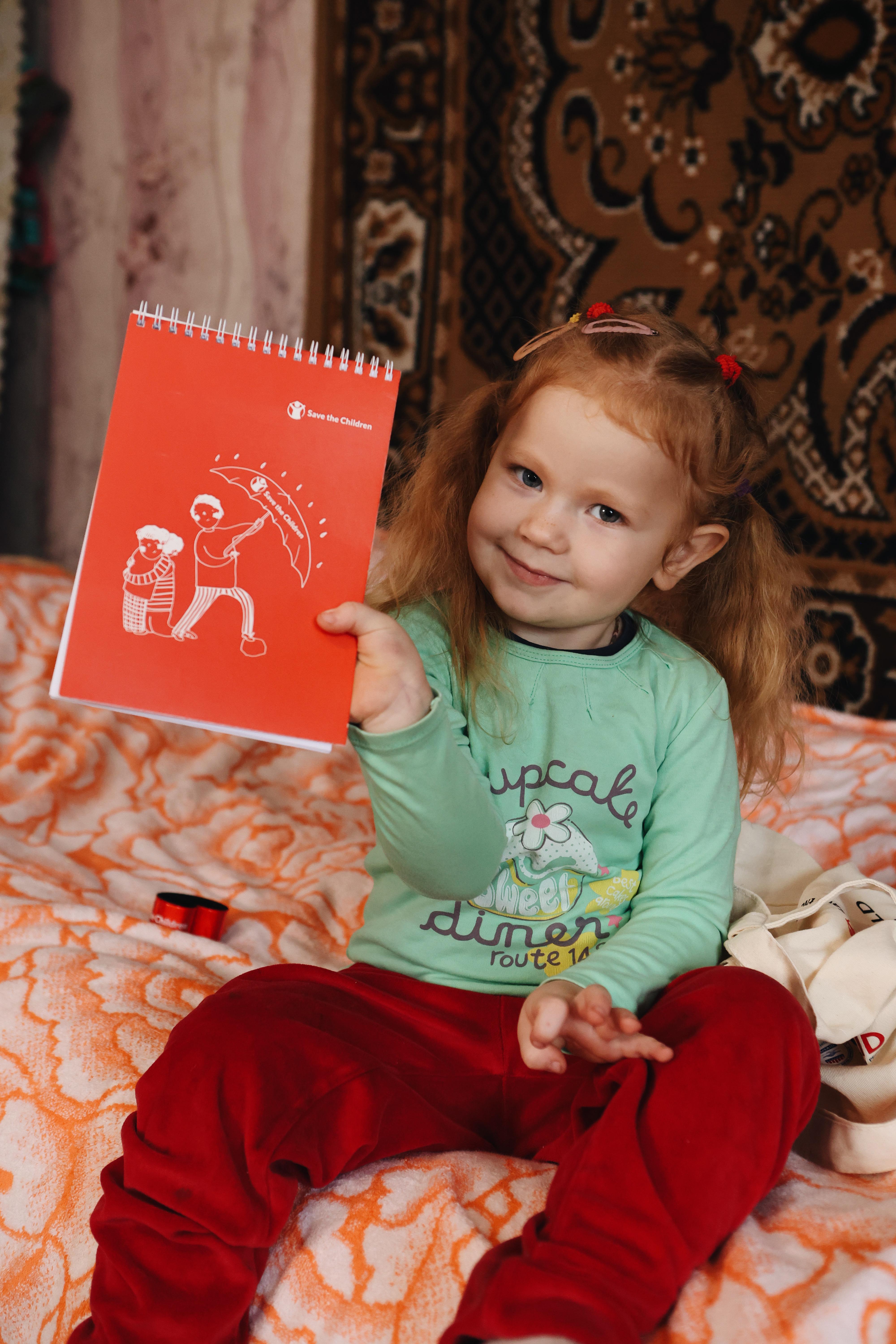 Anna*, 3 poses for a photo in Dnipro region, Ukraine