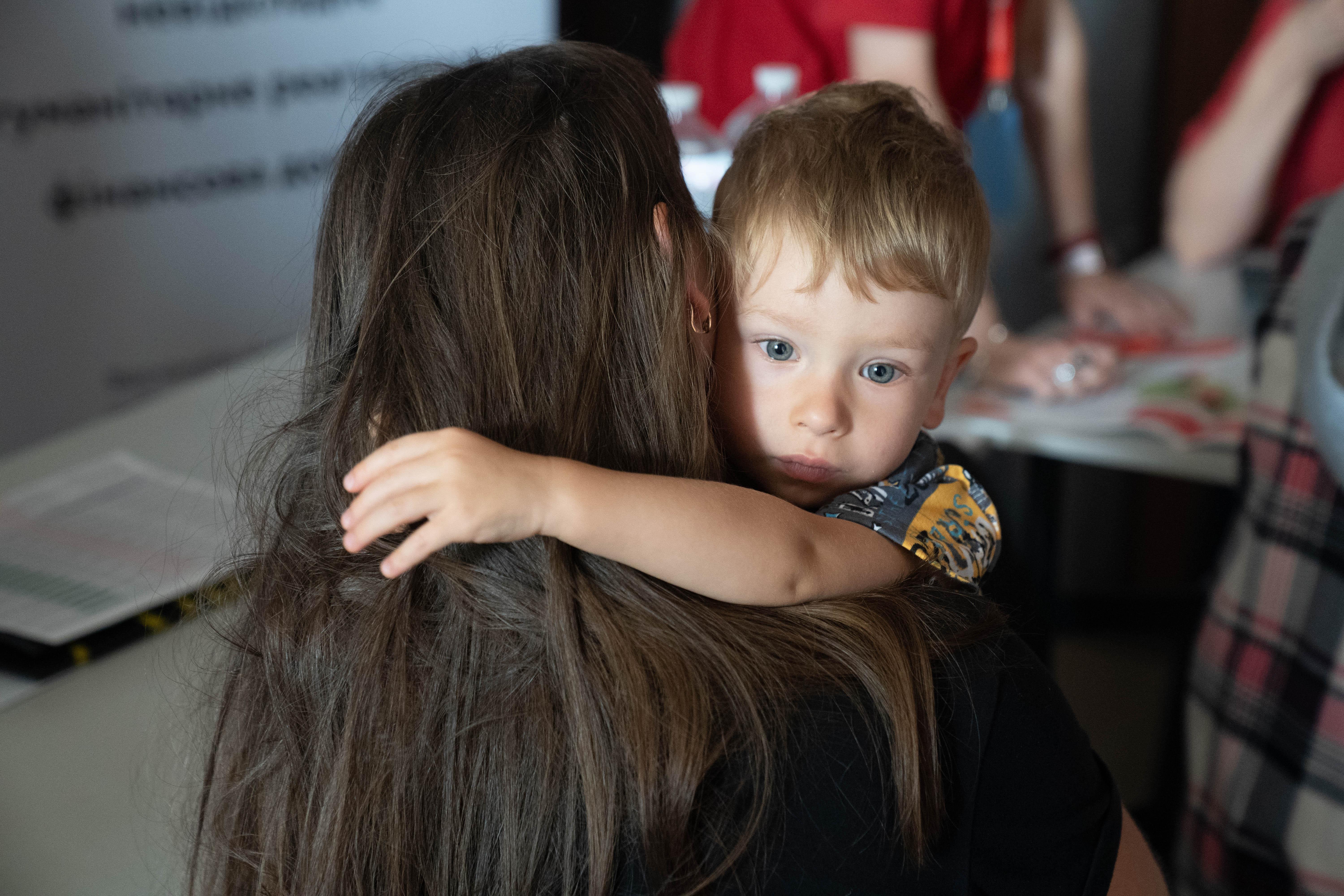 Anton* hugs his mother Anna* in a village in Donetsk region