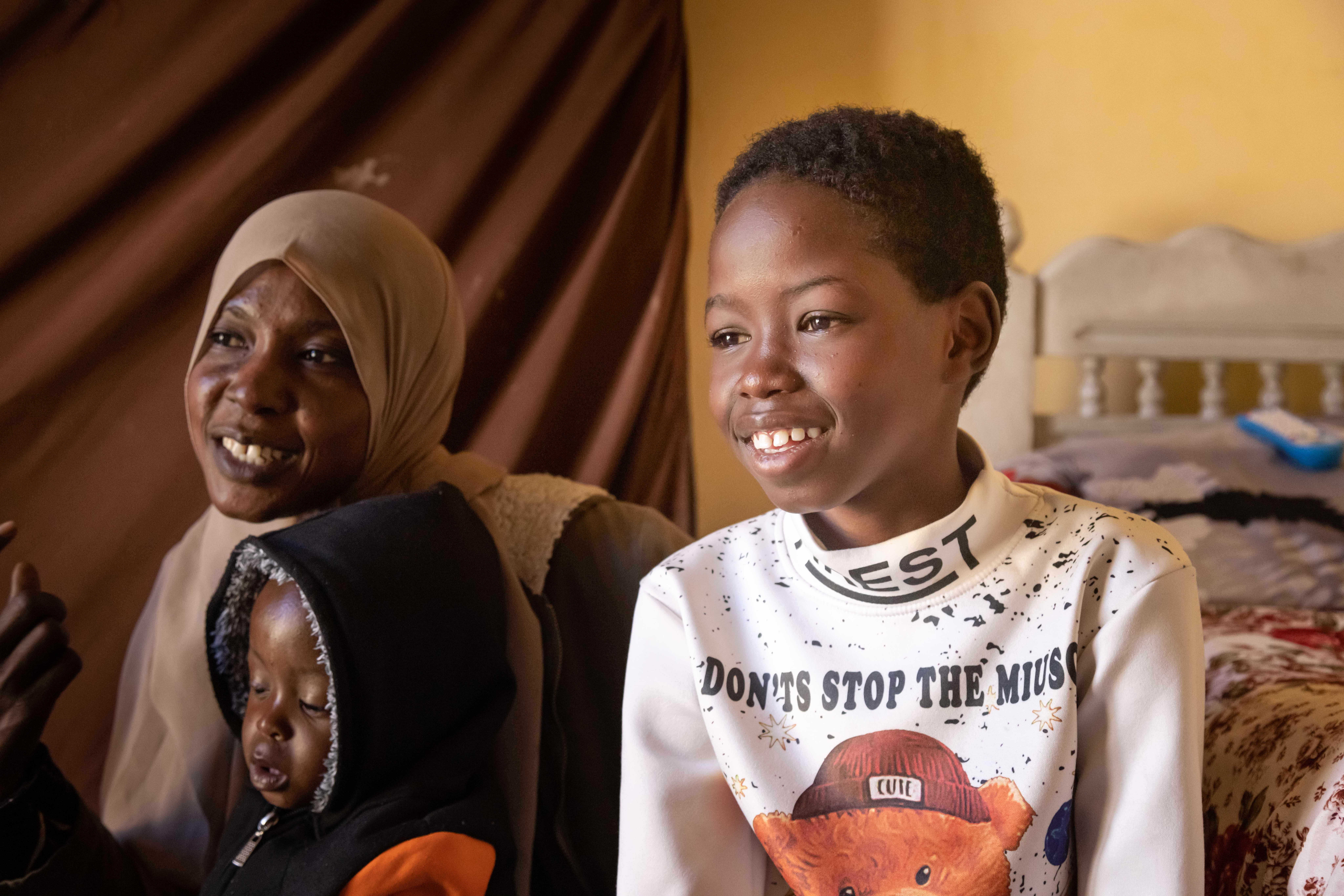 Asaad, 13, and his mother and brother in their home in Cairo, Egypt.