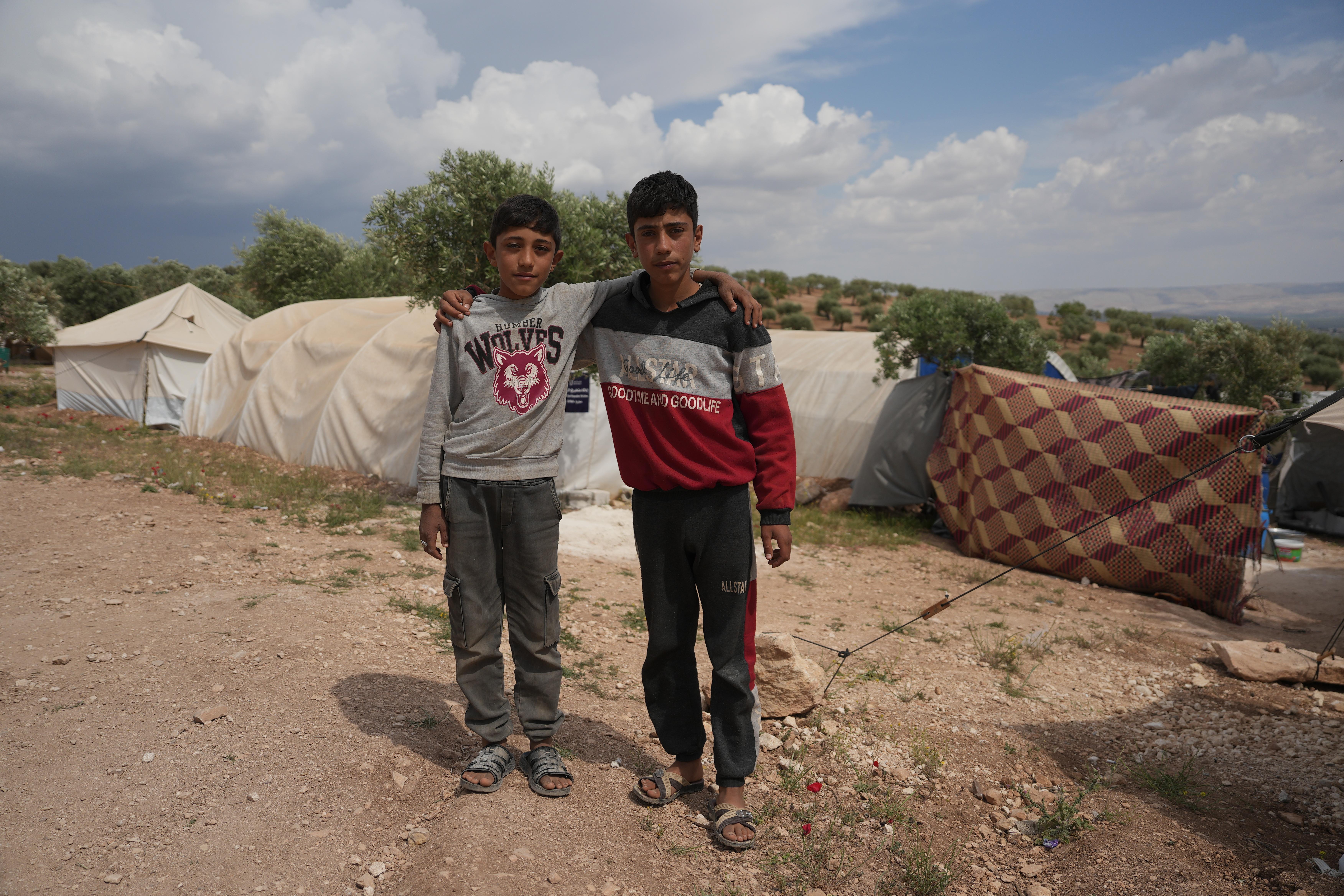 Brothers Munir* and Khaled* stand arm in arm