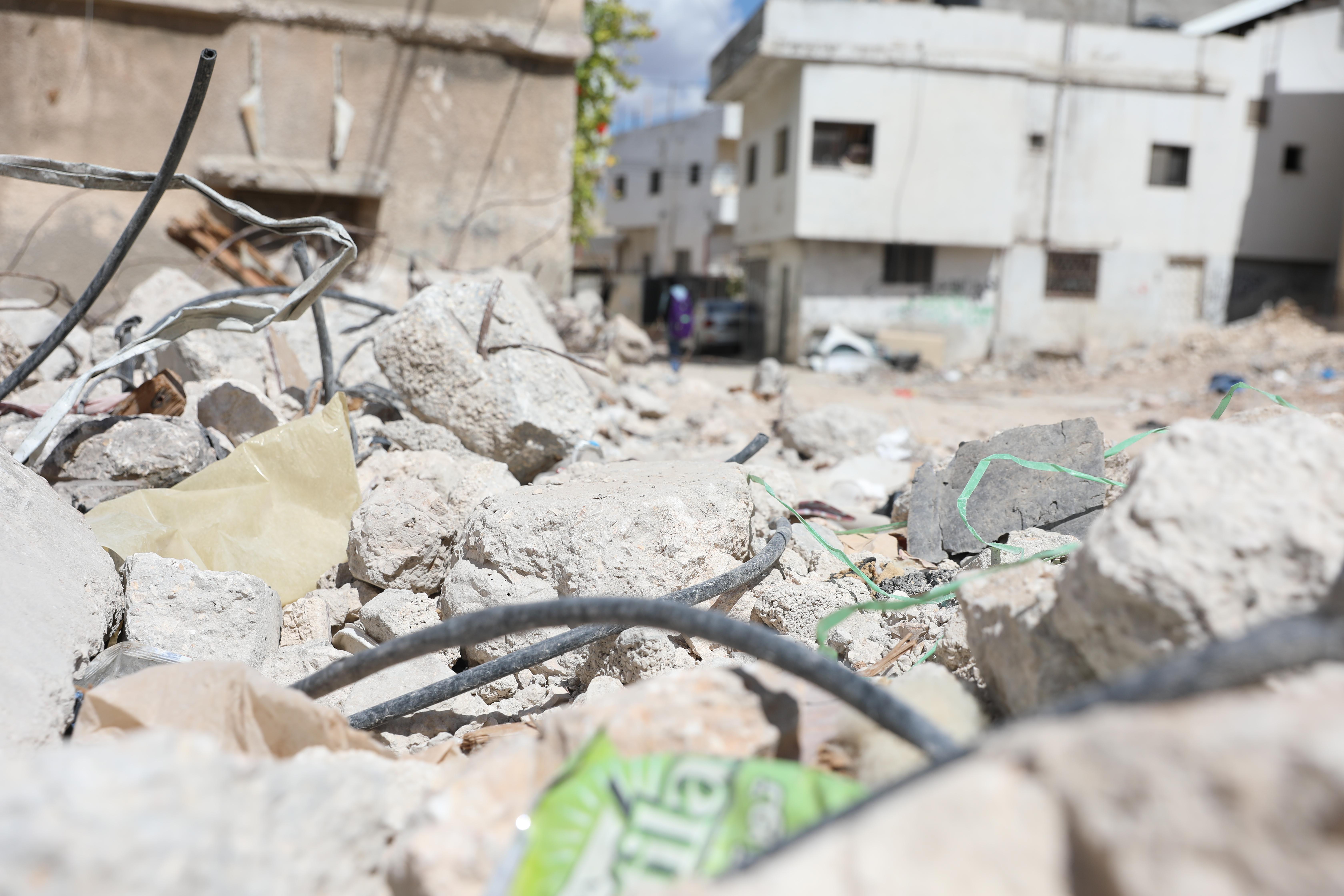 Damaged streets in the neighbourhood where Ruba* and her family live