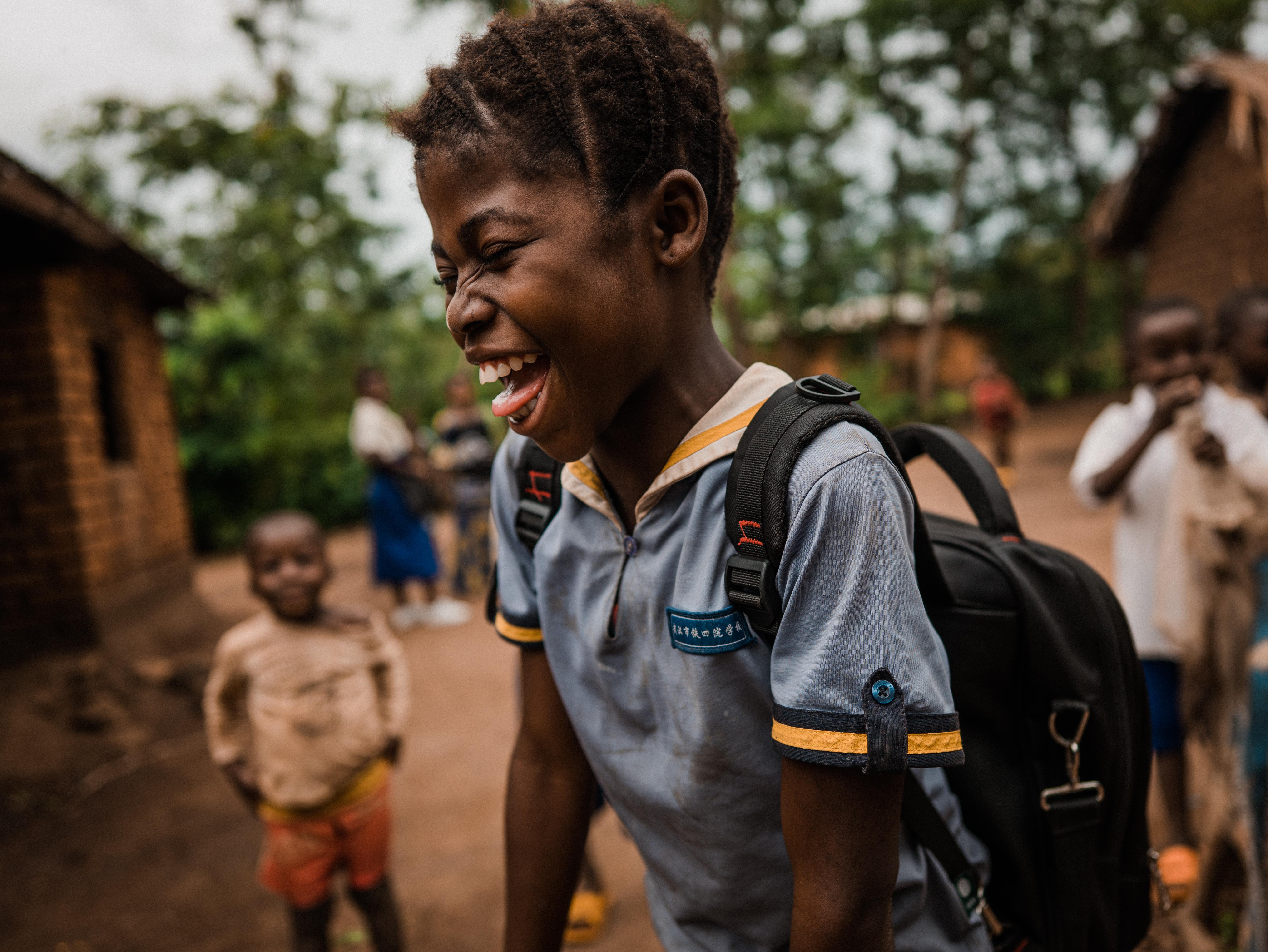 Eléa*, 11, pictured with her school gear a couple of years after being separated from her family for over six months after fleeing conflict in her village in Eastern DRC