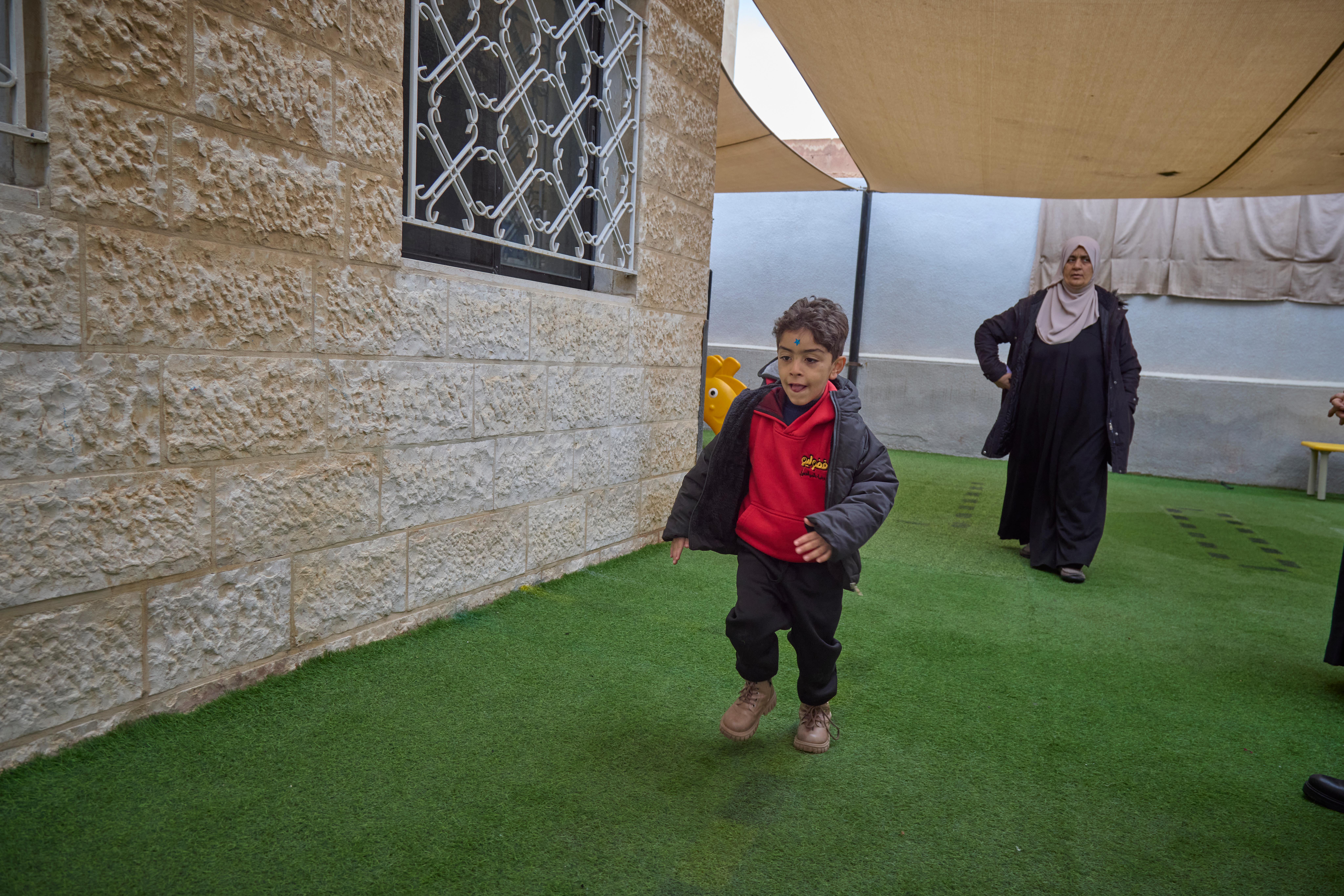 Emran, 5, playing in the playground of Fudulio Pre-school in Al-Zarqa' Governorate, Jordan