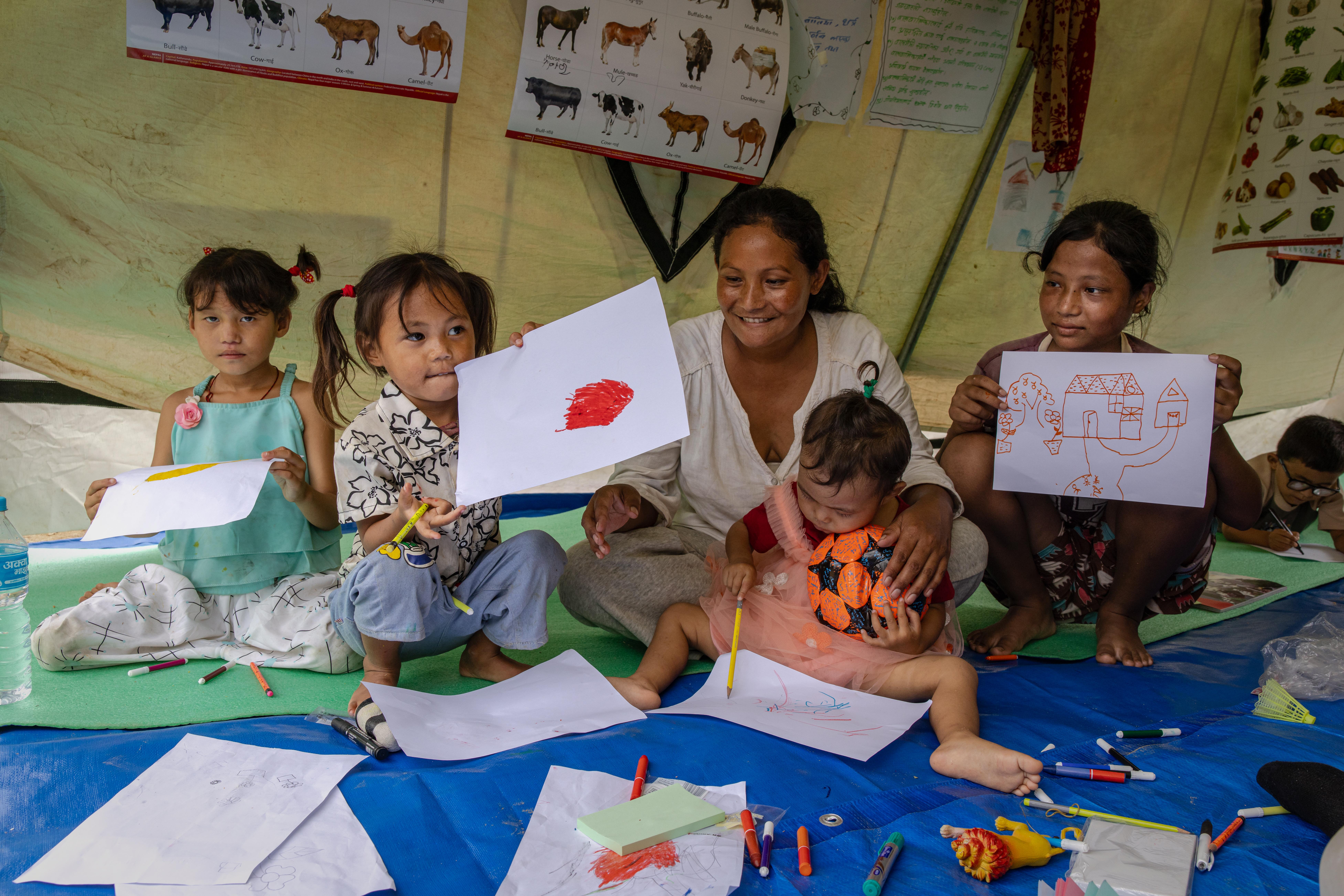 Nisha* with her daughters, Kritika*, 12, Nyra*, 7, Priya*, 4, and Maya*, 2, at a child friendly space in Nuwakot, Nepal.