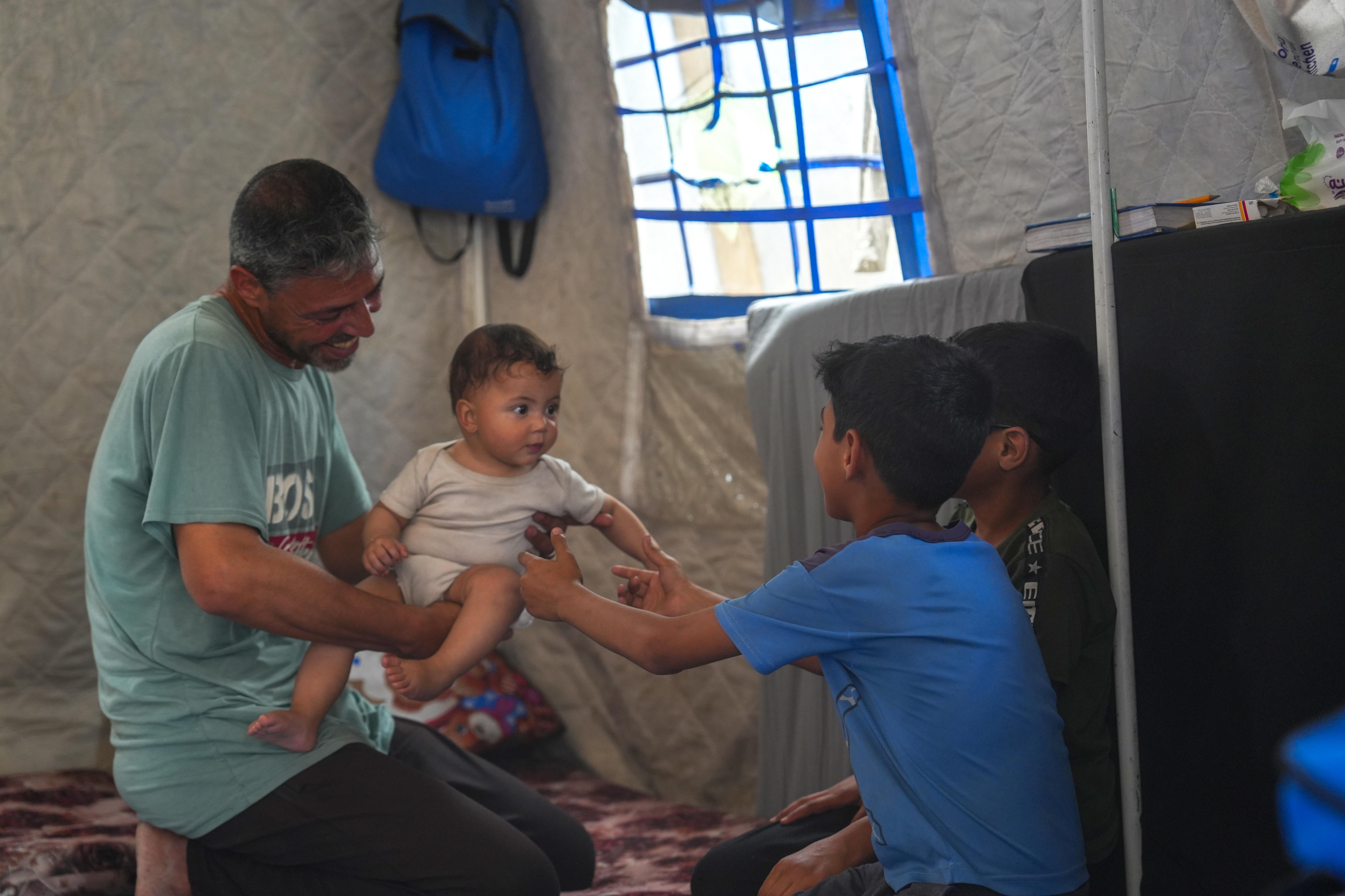 Raheem* (46), father of five, plays with his children
