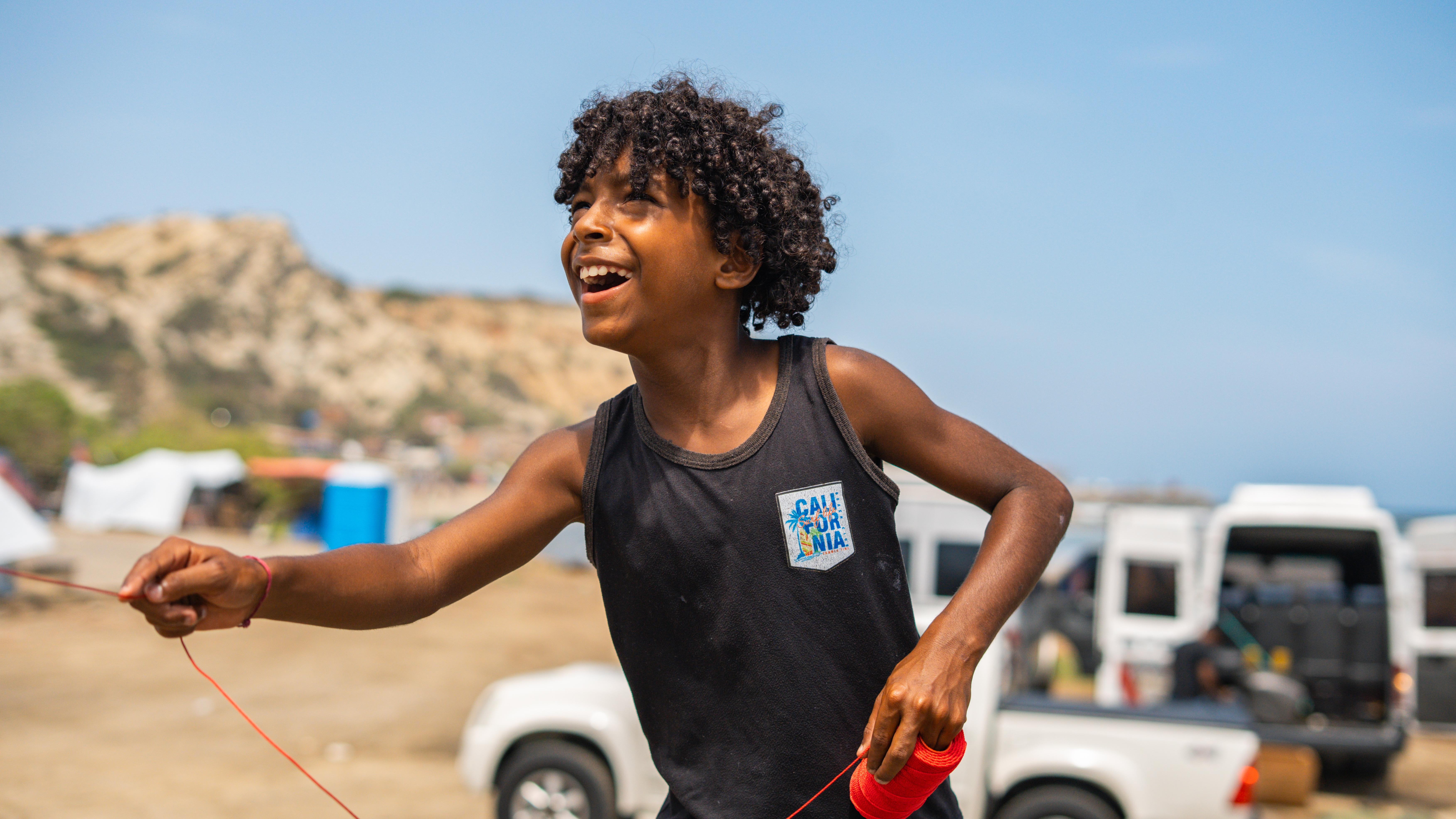 Román*, 10, flying his kite