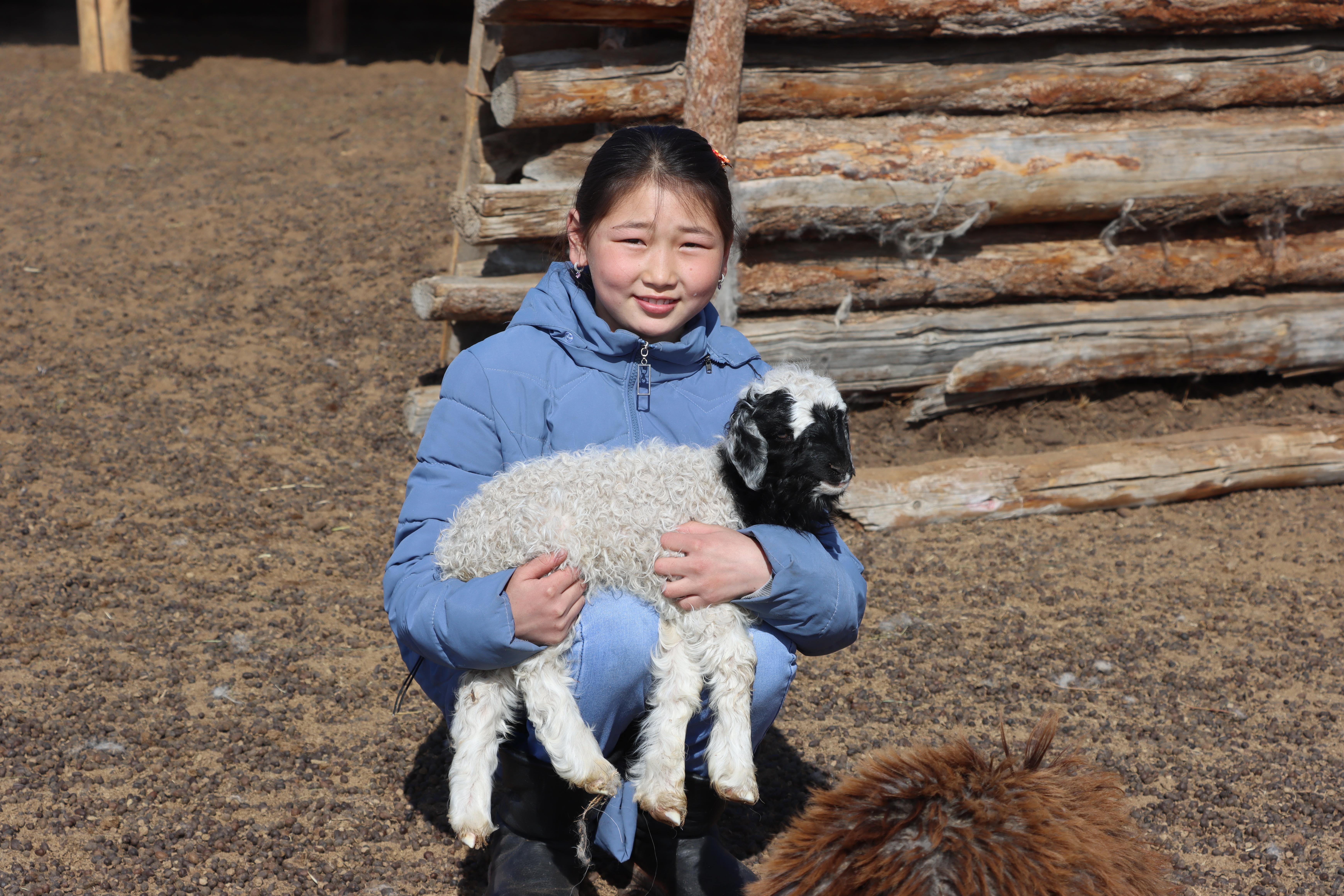 Yesun-Erdene, 13, looking after animals near home in a village in Zavkhan Province, western Mongolia