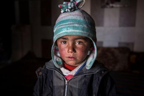 Saeed*, three, inside an abandoned petrol station where he and his family now live. The petrol station, badly damaged by war, is now the home of five families who have returned to Tel Abiad district, Raqqa Governorate, Syria, after fleeing from ISIS two years earlier only to find their homes destroyed. Save the Children