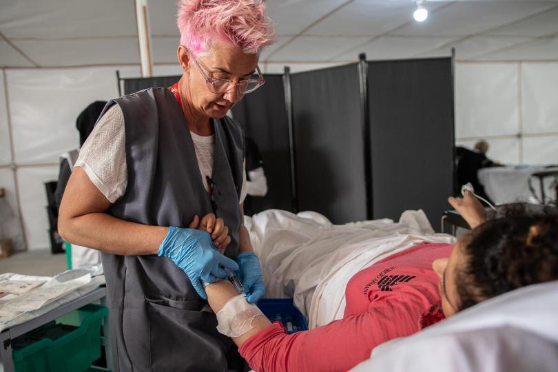 Save the Children's paediatric nurse, Becky, provides Solave* (13) with pain relief while her leg wounds are cleaned and bandaged at a