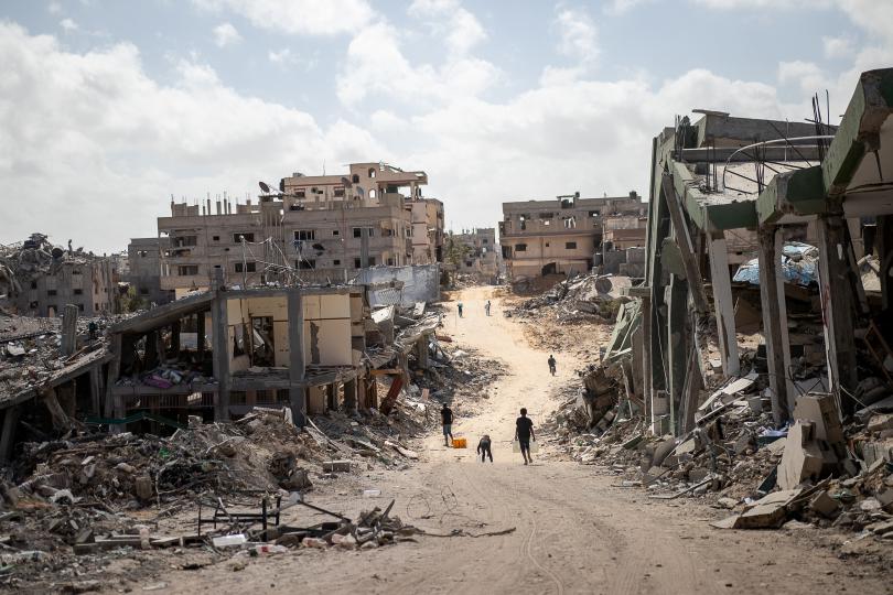 Children walk down the destroyed streets of Khan Younis, the Gaza Strip