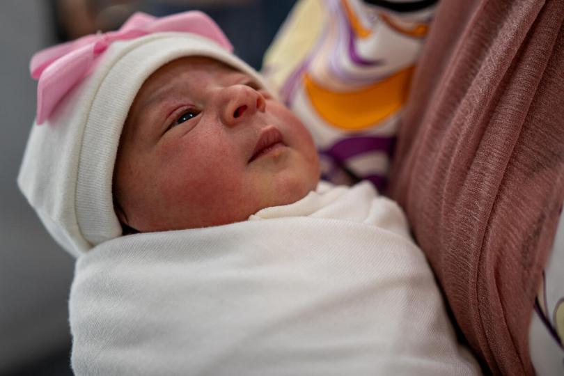 Eileen* (49) holds her one-day-old granddaughter Lana* at a Save the Children maternity unit, Gaza