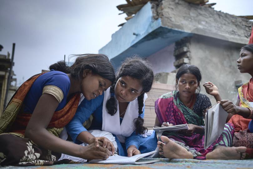 Munni and her friends teaching a community literacy class