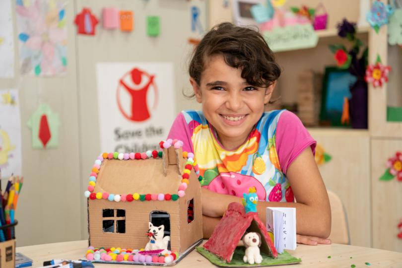 Najma*, 12, with her artwork at a Save the Children education centre in a camp for Syrian refugees in Iraq