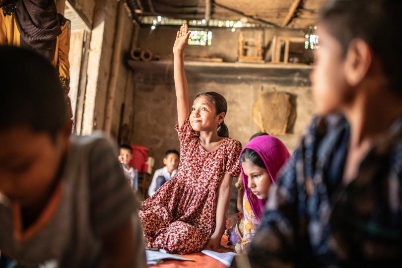 Taslima, 10, puts her hand up in class at her community school - Sylhet, Bangladesh