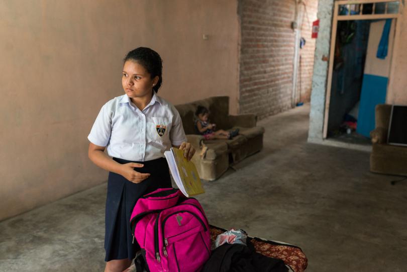 Leonara*, 13, a Venezuelan migrant living in Peru, packing her books for school in 2019