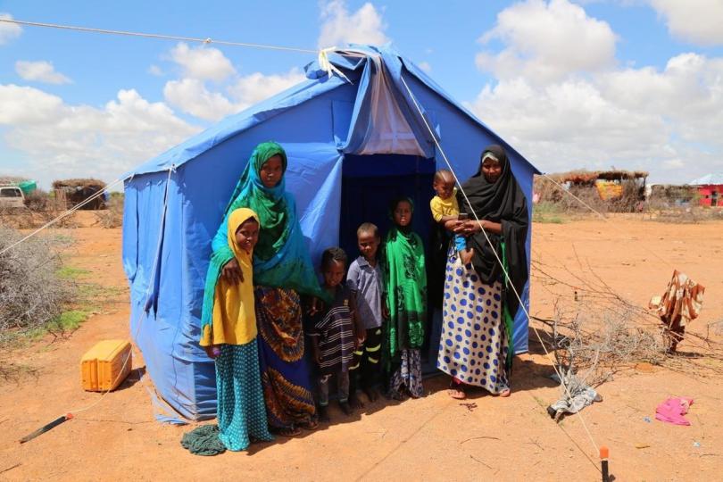 Amran (second from left) with her mother Amina and five siblings outside their tent in a camp for people displaced by the floods in Beledwayne