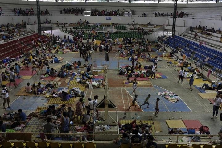 Families sheltering in Bauan Cockpit Arena which now serves as an evacuation centre