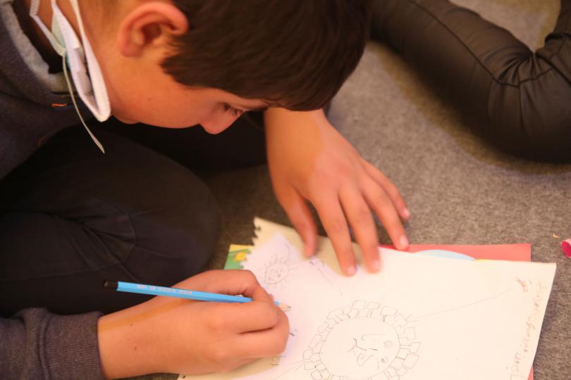 Rami*, 13, draws the coronavirus at home in a camp in North West Syria