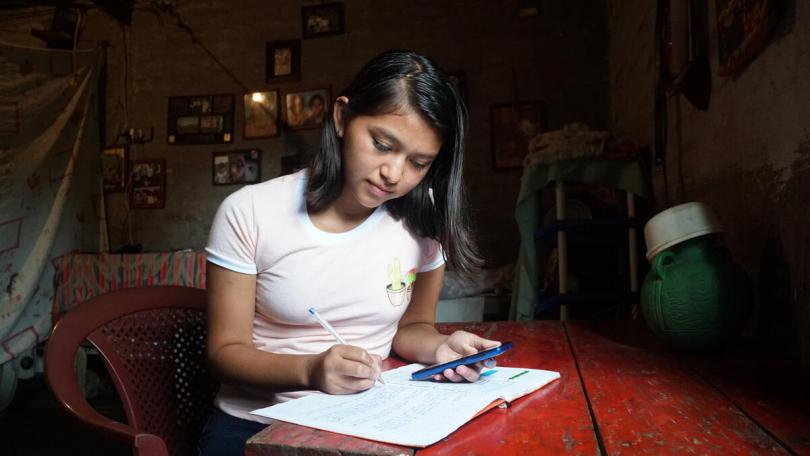 Dayana's school is closed due to the pandemic so she has to study from home using her mobile phone. Dayana is a 15-year-old girl who lives in the Sonsonate region in El Salvador.