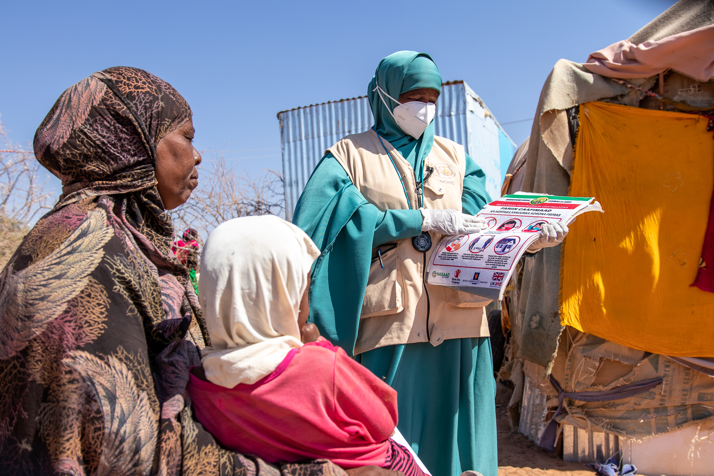 Muna showing guidance to a mother and child