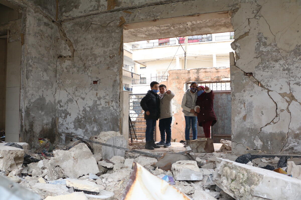 Mustafa*, 10, Bilal*, 10, and Sara*, 10, in the section of their school which was damaged by an airstrike