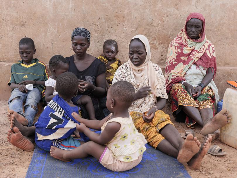 Issouf, aged 7, his mother Sandrine* and relatives outside their home in Yatenga province, Burkina Faso