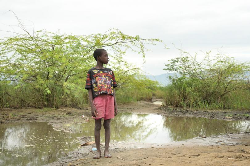Luciano, 12, standing by the devestation left by Cyclone Ana and floods in Malawi