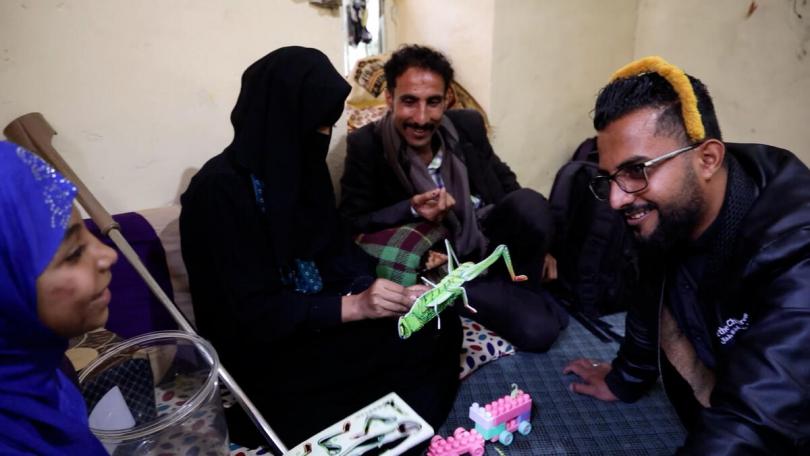 Maha*, 10, Maya*, 16, & Jamal*, 38, play with Jihad, a Save the Children psychosocial support volunteer who survived a landmine incident too, at their home in Taiz,
