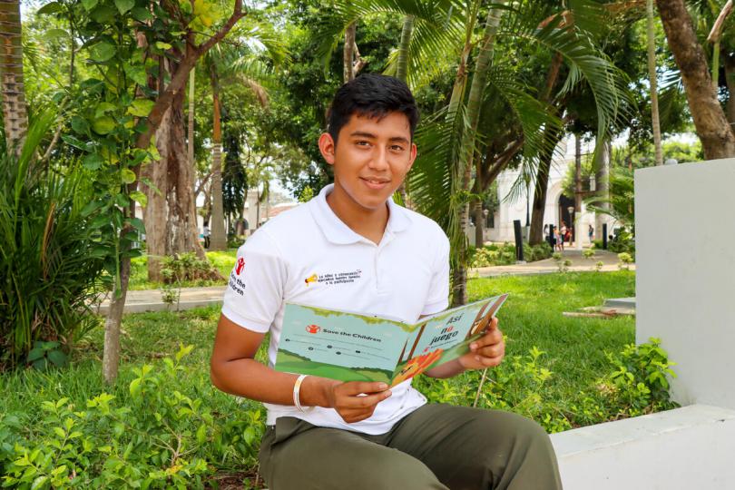Ernesto, 17, reading one of his favourite Save the Children books.