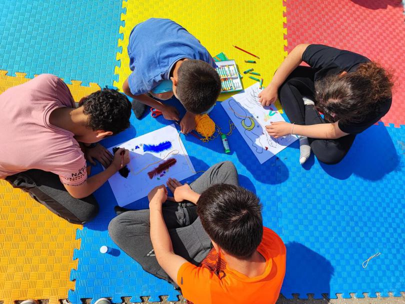 Following the February earthquake, a group of children draw during a psychosocial support session in Türkiye