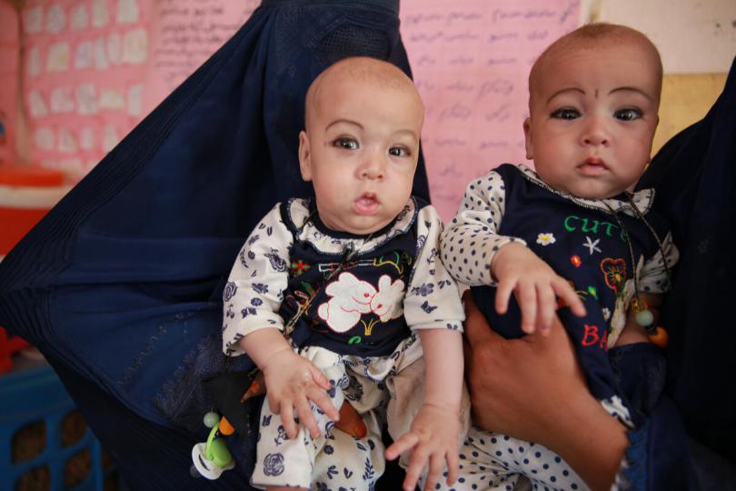 Sahida visiting Save the Children's Mobile Health team with her twins, Nahida and Nadira (8 months old) for a malnutrition screening