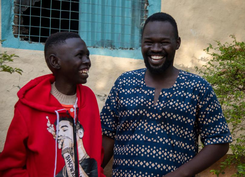 Simon*, 13, with his brother Samuel*, 27, at home in Juba, South Sudan, after Simon* was reunified with his family.