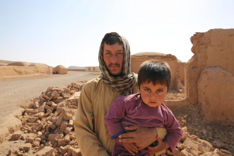 Edris* (30) and his son Jawid* (4) to their community affected by the recent earthquake in Herat.