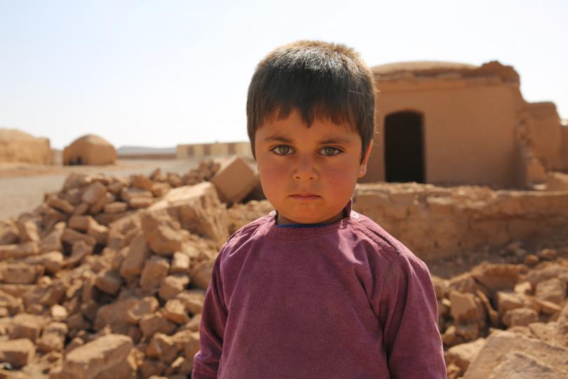 Jawid*,4, stands in front of his collapsed home in, following the earthquakes in Herat province, Afghanistan. 