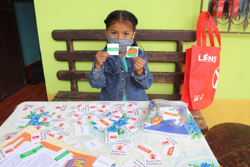 A young girl learns at home with a memory card game, Guatemala