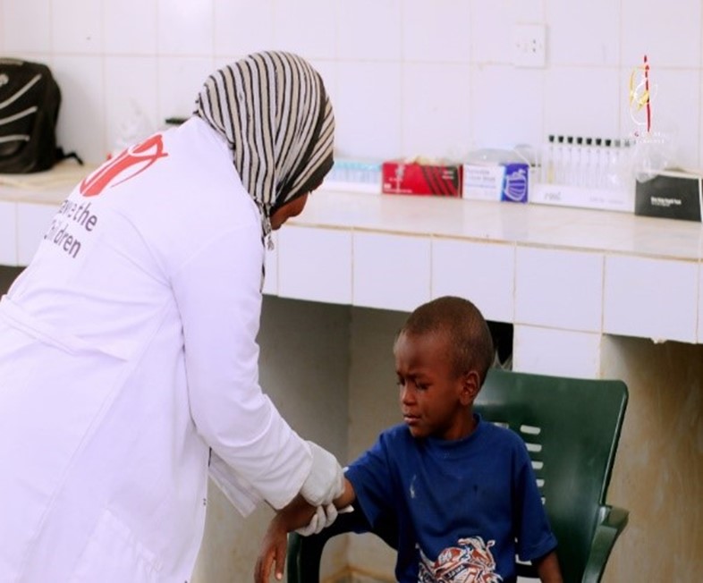 Khalida attending a child at the health centre