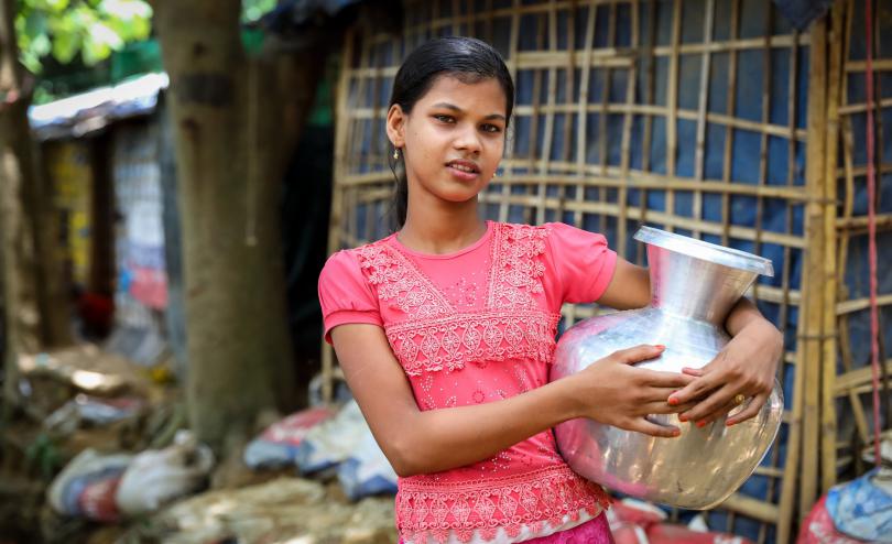  Ayesha,* age 12, holds a water container in Cox’s Bazar, Bangladesh. The first confirmed case of coronavirus was reported in Cox Bazar, where one million Rohingya refugees have been sheltering in sprawling camps since August 2017.