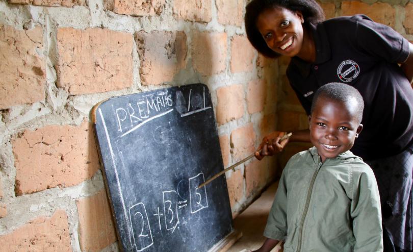 A young student practises pre-school maths (before COVID-19)