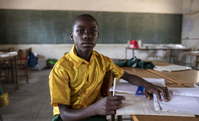 A boy sits in his classroom in Zimbabwe after a session on DRR